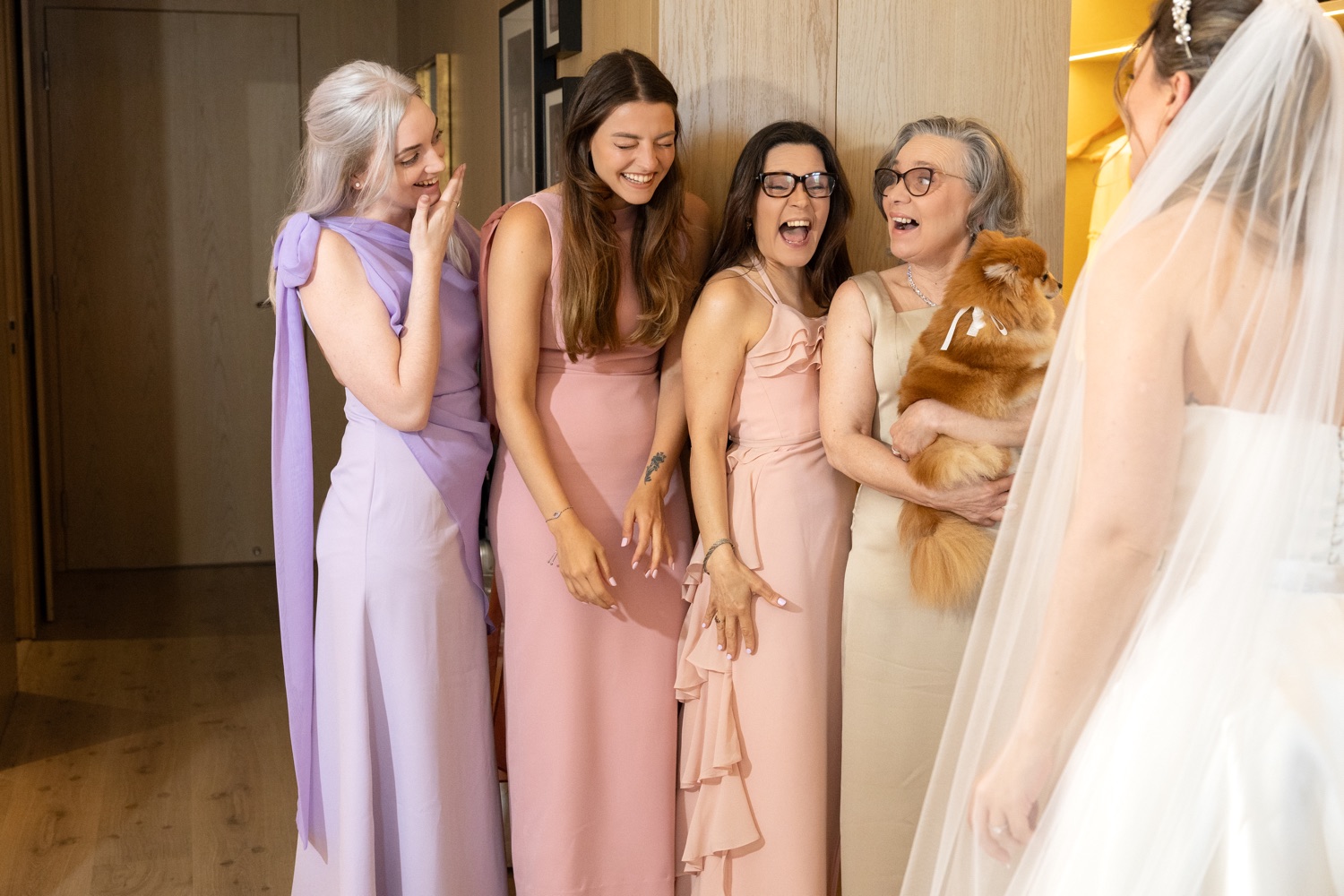 The bridesmaids in their dresses, laughing before the ceremony